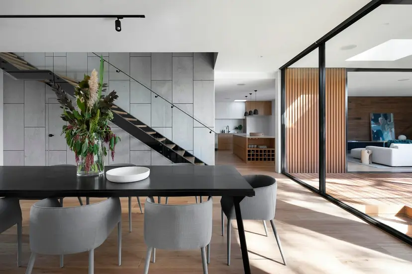 Covered patio with an outdoor kitchen, built-in grill and dining seating in a Southern California backyard